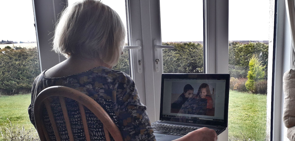 grandmother and grandchildren talking on Skype